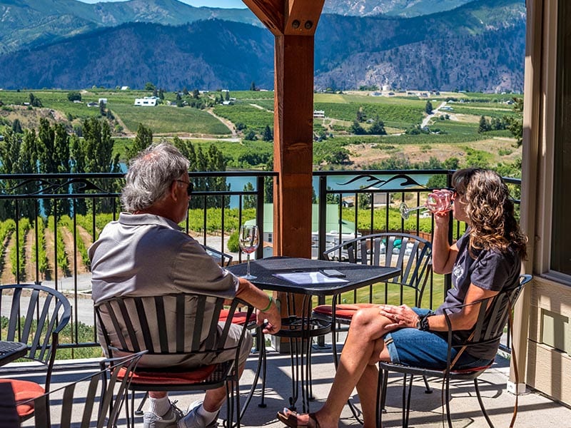 man and a woman drinking wine on an outdoor patio