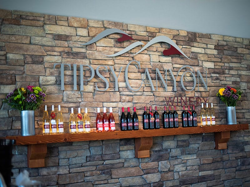 Tipsy Canyon Winery mantle featuring wine bottles
